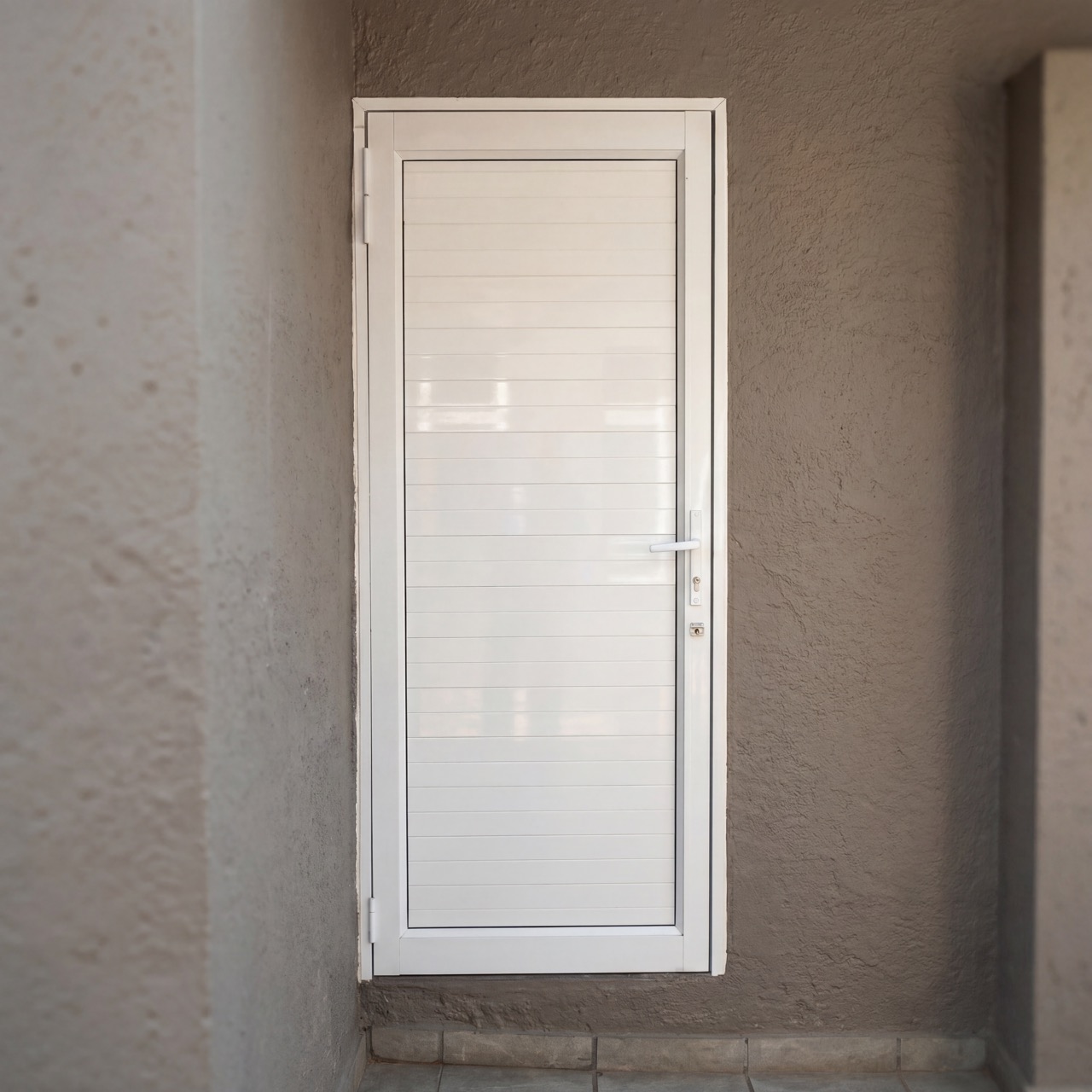 White aluminium entrance door installation