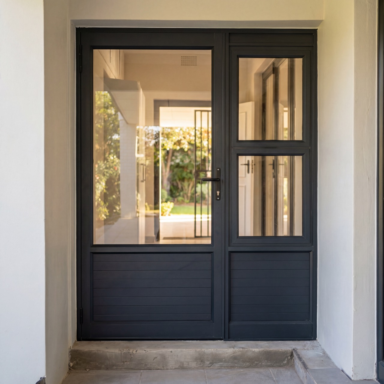 Dark-framed glazed entry set with sidelights