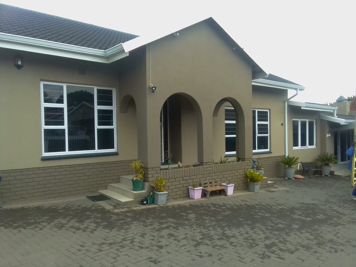 full residential exterior with white aluminium windows throughout