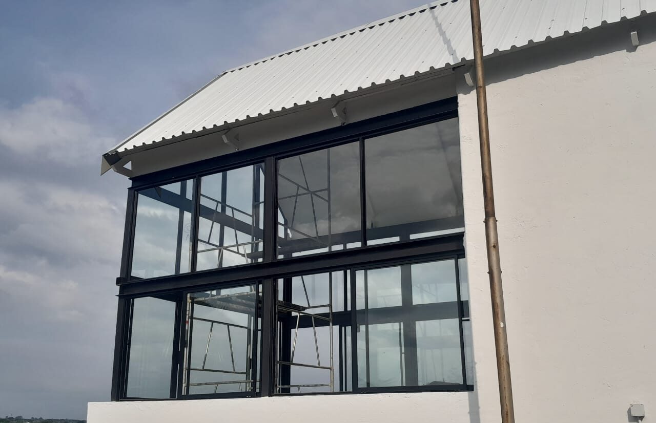 upper-floor aluminium curtain glazing under a pitched roof