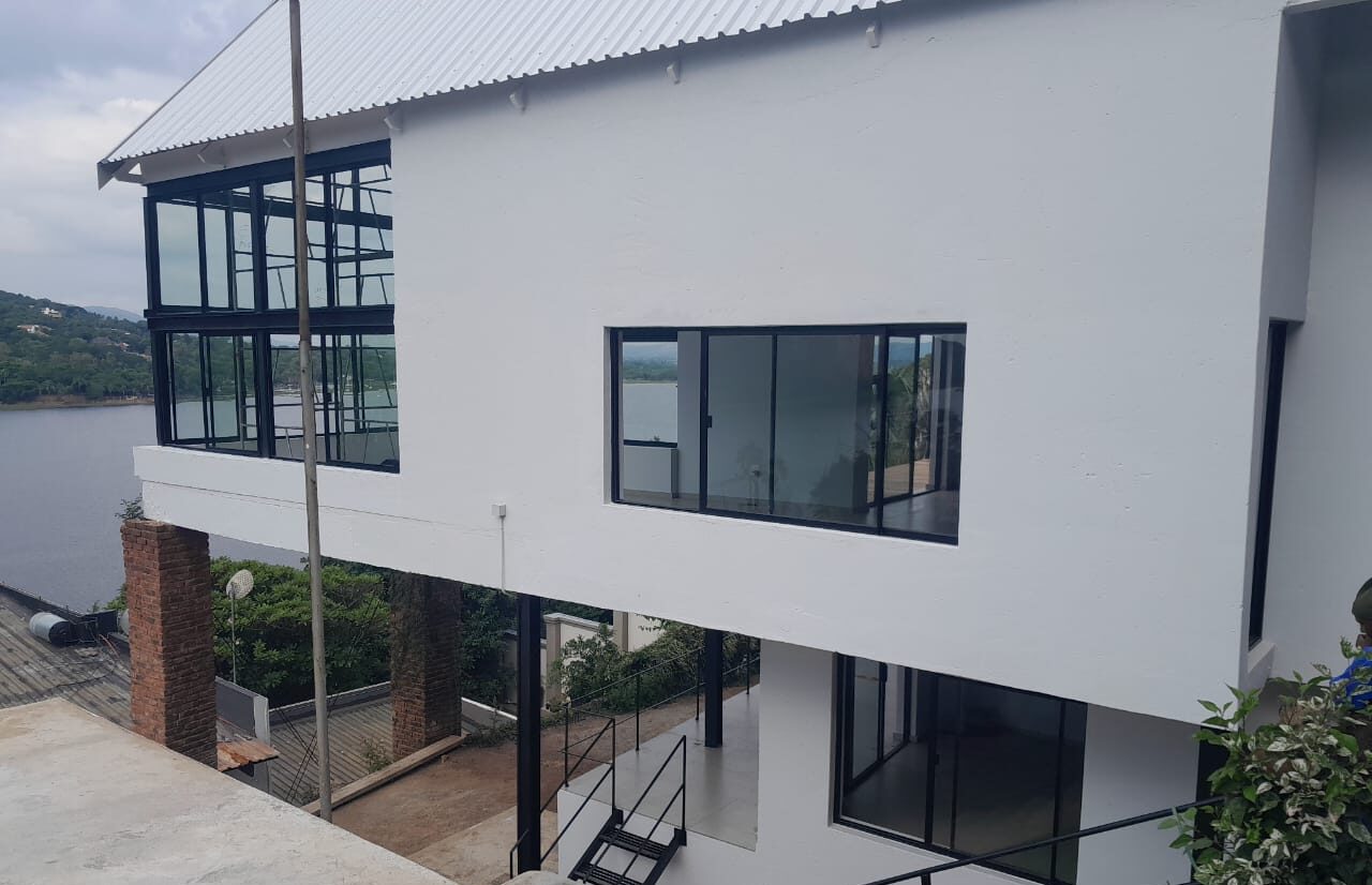 lakeside home elevation with charcoal aluminium sliding doors and windows